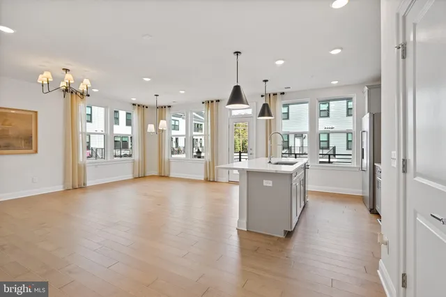 a large kitchen with a large window and stainless steel appliances