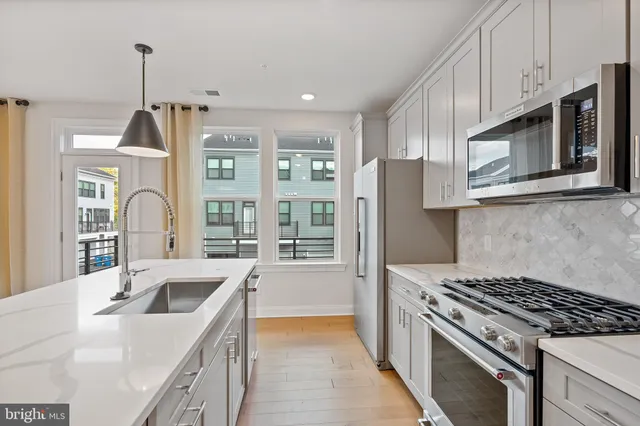 a kitchen with stainless steel appliances granite countertop a stove and a sink
