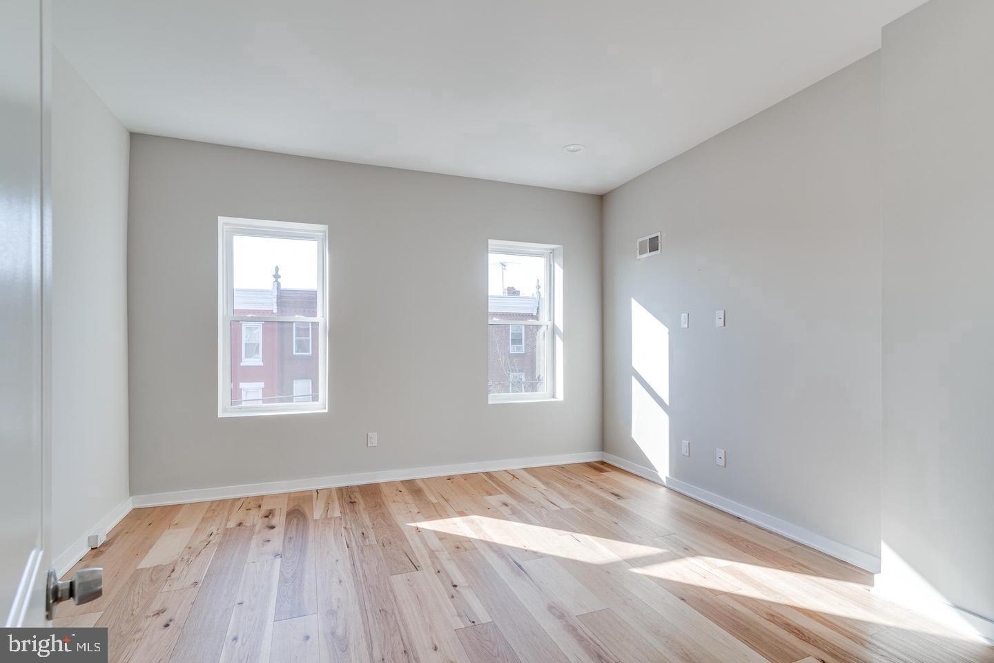 1503 North 29th Street Philadelphia, PA 19121 - Photo 12 of 27 an empty room with wooden floor and windows