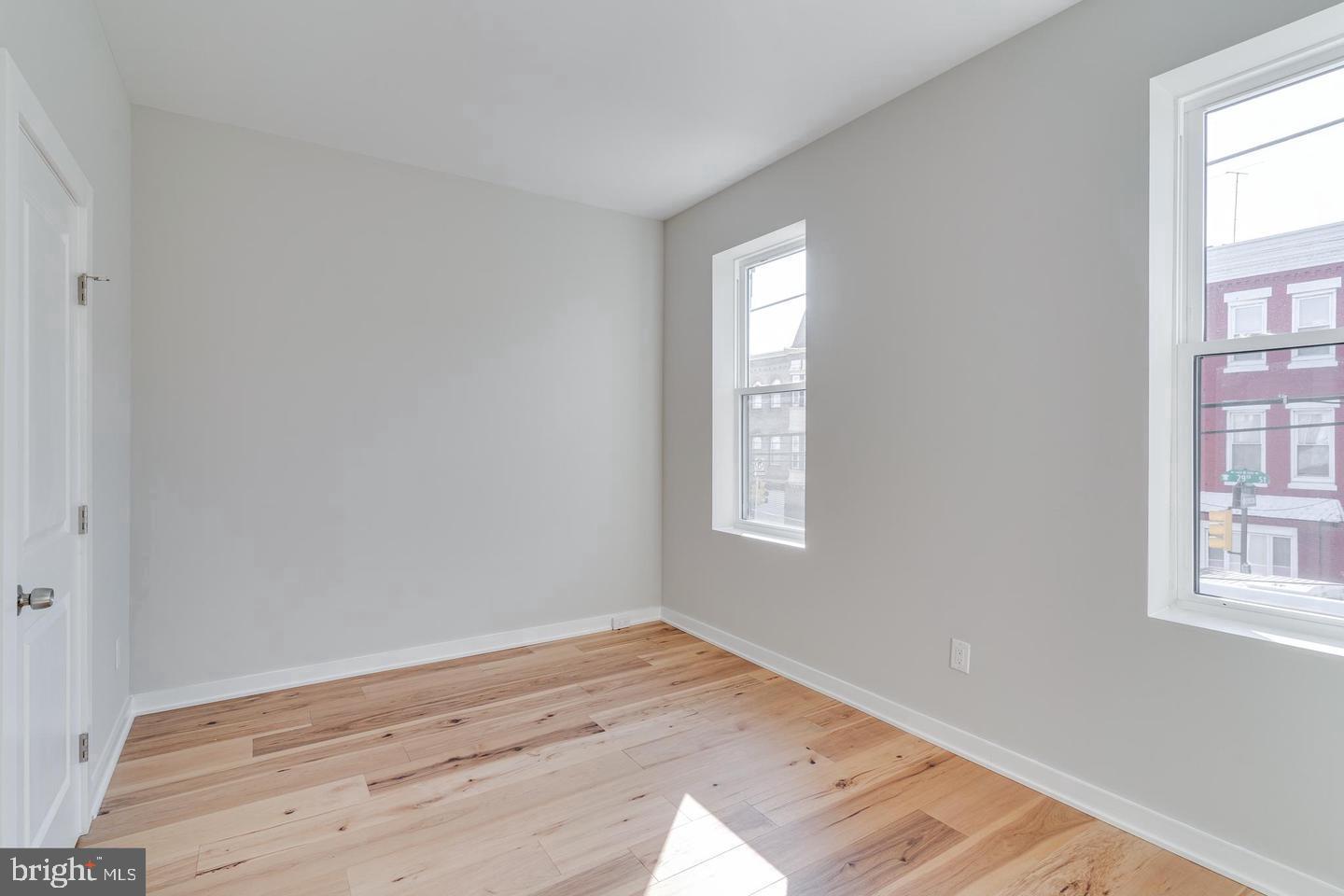 1503 North 29th Street Philadelphia, PA 19121 - Photo 19 of 27 an empty room with wooden floor and windows
