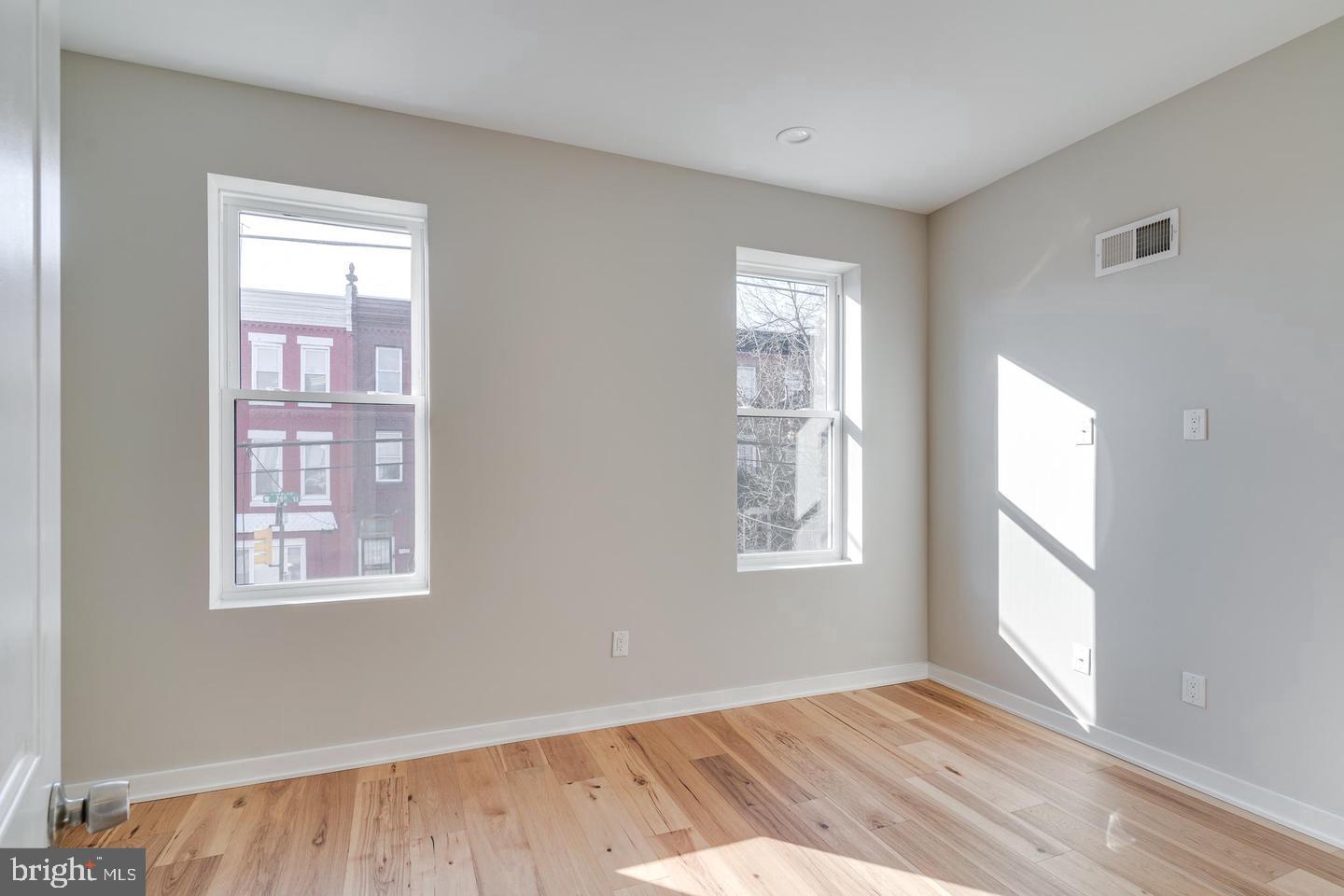1503 North 29th Street Philadelphia, PA 19121 - Photo 20 of 27 a view of an empty room with wooden floor and a window