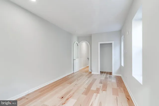 a view of a room with wooden floor and white walls