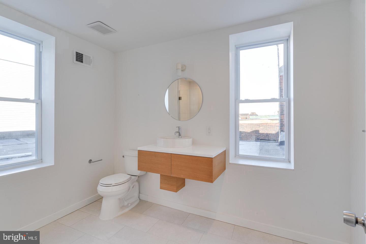 1503 North 29th Street Philadelphia, PA 19121 - Photo 9 of 27 a room with painting on the wall and a window