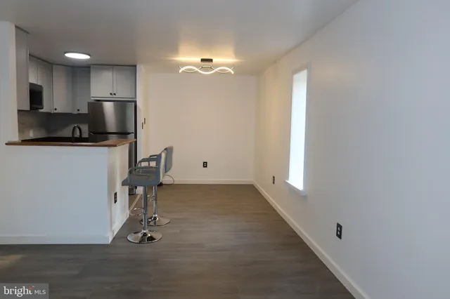 a view of a kitchen with workspace and windows