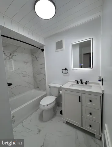 a bathroom with a sink a toilet and bathtub
