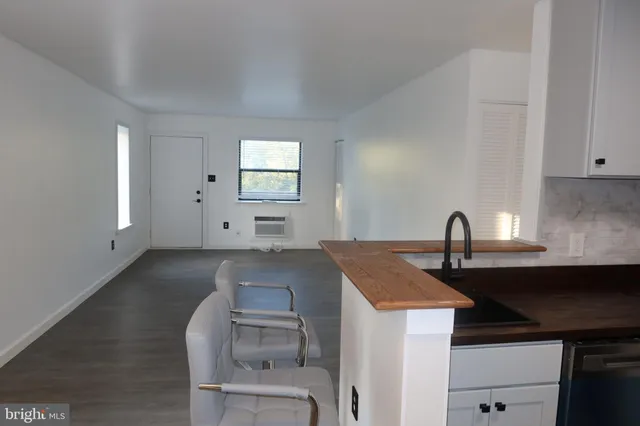 a kitchen that has a sink and a stove in it