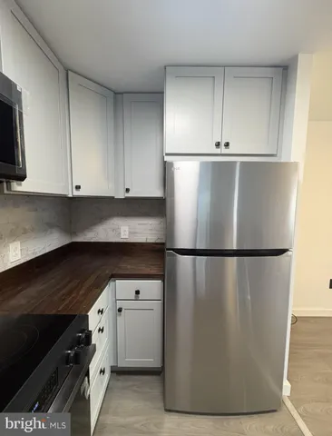 a white refrigerator freezer sitting in a kitchen
