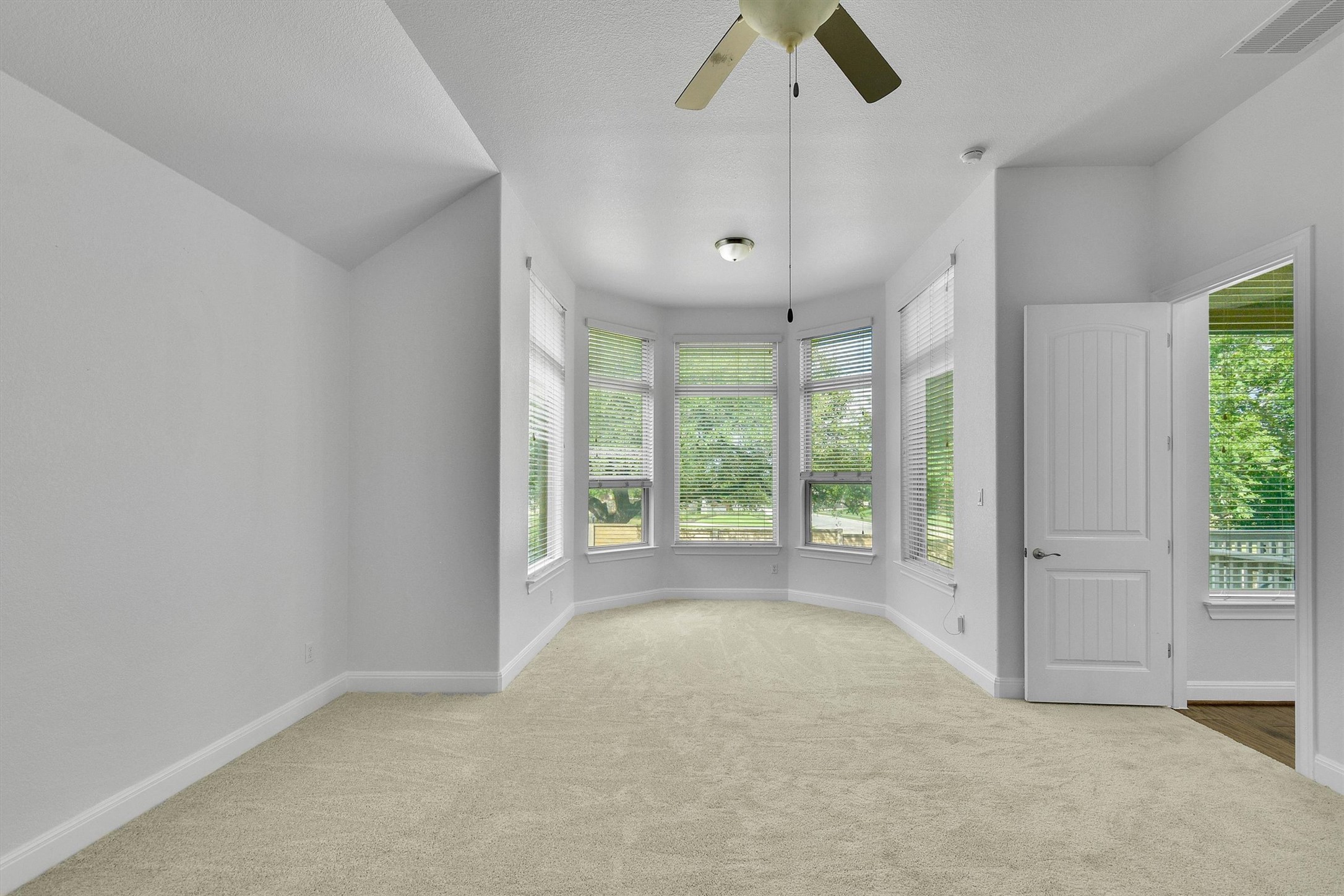 2325 Blended Tree Ranch Drive Leander, TX 78641 - Photo 16 of 35 A spacious room offers ample natural light through a series of broad windows, perfect for relaxation or productive work.