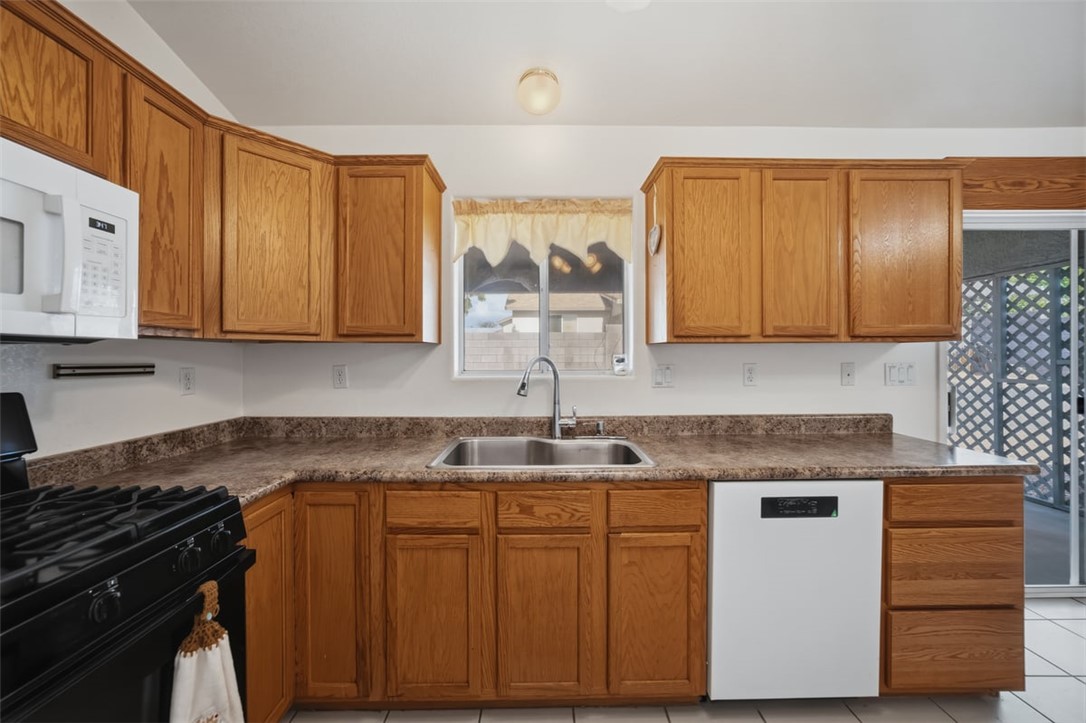 2144 Ridgeview Road Kingman, AZ 86401 - Photo 18 of 49 a kitchen with stainless steel appliances granite countertop a sink stove and microwave