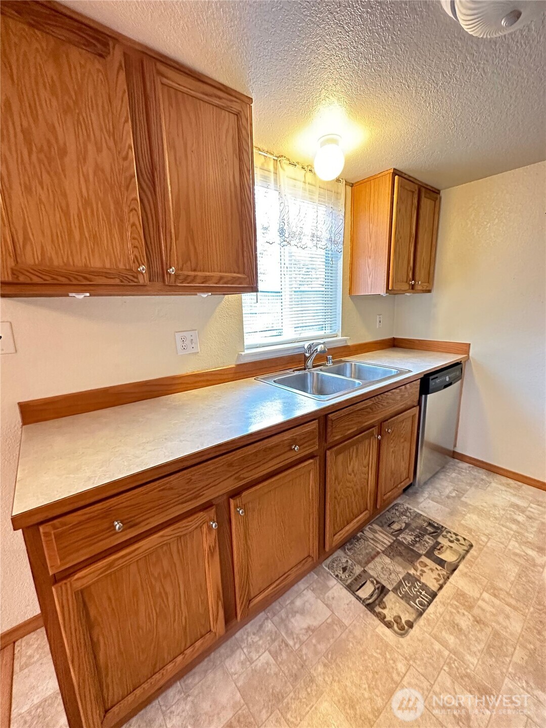 9105 1st Place Northeast, Unit 2 Lake Stevens, WA 98258 - Photo 3 of 13 a kitchen with a sink cabinets and wooden floor