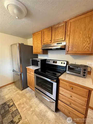 a kitchen with a stove and a refrigerator