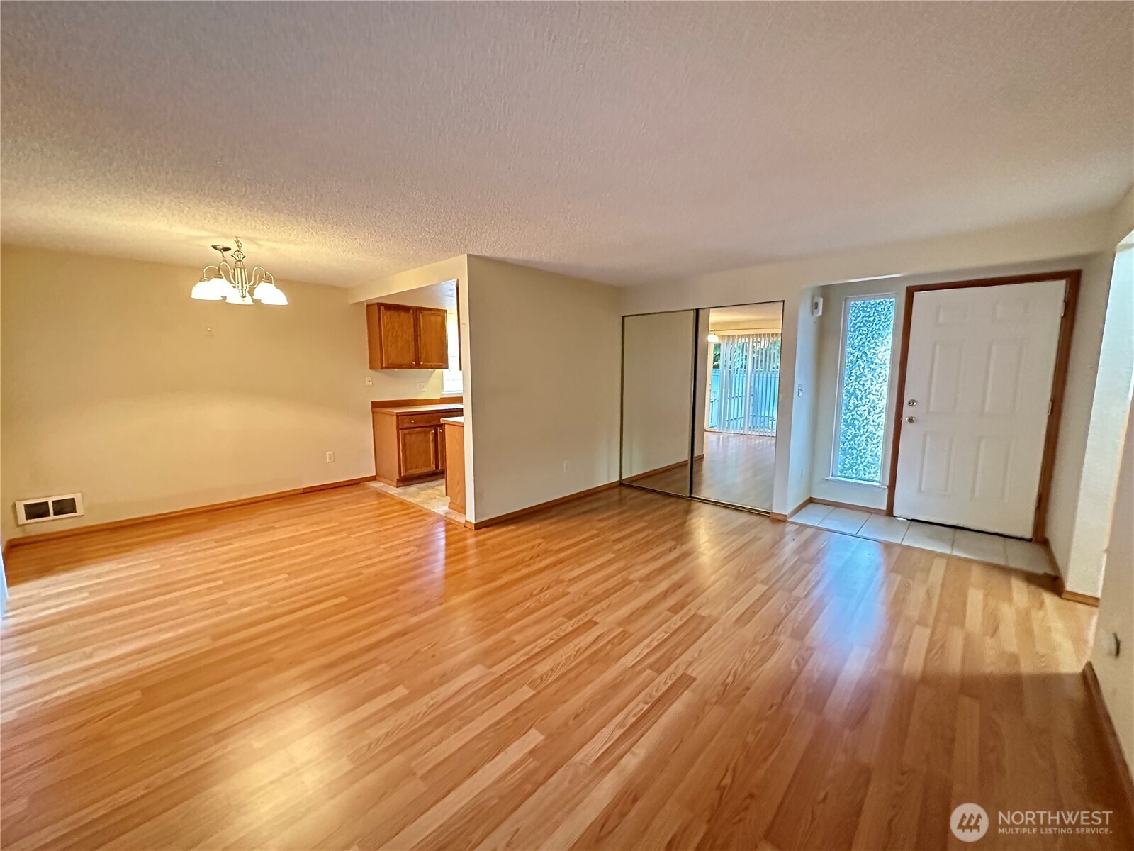 9105 1st Place Northeast, Unit 2 Lake Stevens, WA 98258 - Photo 7 of 13 wooden floor in an empty room with a window