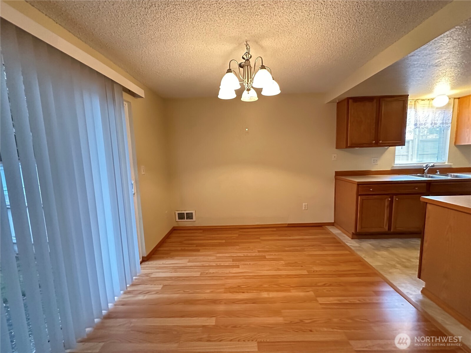 9105 1st Place Northeast, Unit 2 Lake Stevens, WA 98258 - Photo 8 of 13 a view of an empty room with wooden floor and a window