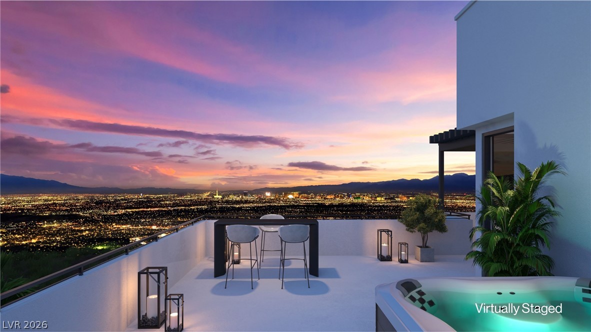 507 Overlook Rim Drive Henderson, NV 89012 - Photo 14 of 22 Rooftop deck with a hot tub and seating offers sweeping city lights and mountain vistas.