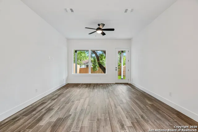 wooden floor in an empty room with a window