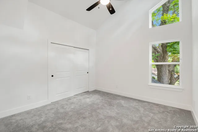 a bathroom with a granite countertop sink a toilet and bathtub