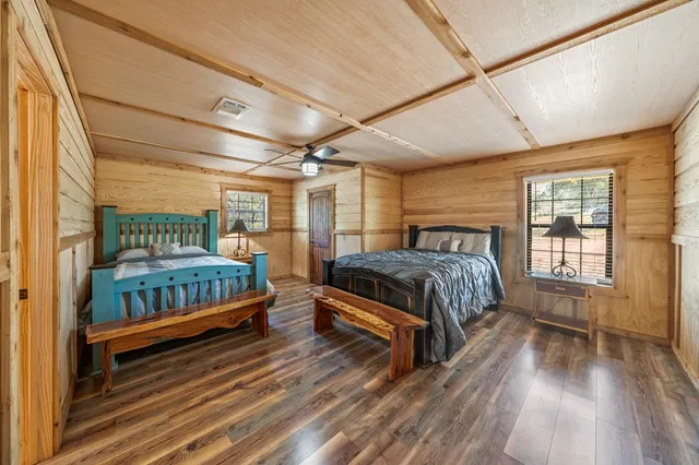 a bedroom with a bed next to a window