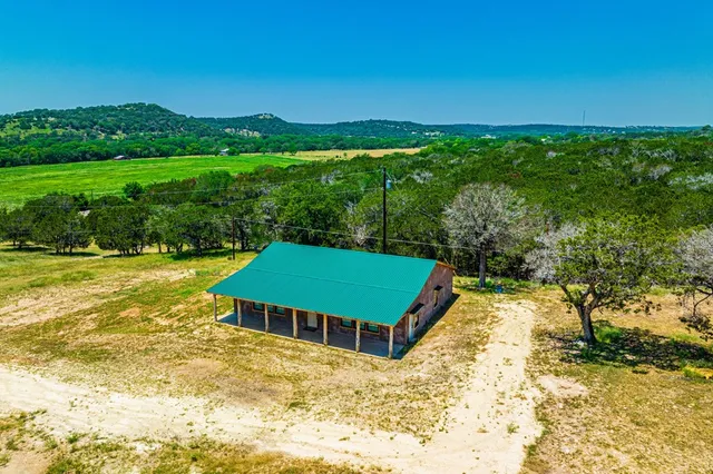 a view of a swimming pool with a yard