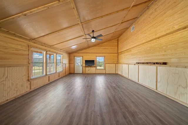 a view of a room with wooden floor