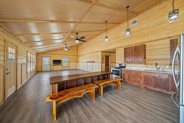a kitchen with a wooden floor and breakfast area