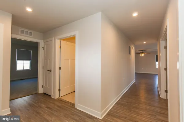 a view of a hallway with wooden floor