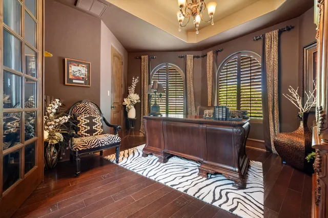 a dining hall with stainless steel appliances kitchen island granite countertop a table and chairs in it