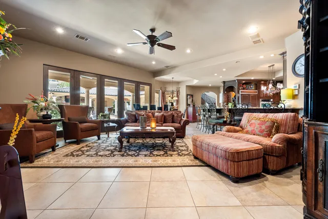 a bedroom with bed a ceiling fan and a large window