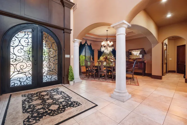 a view of a dining room with furniture and chandelier