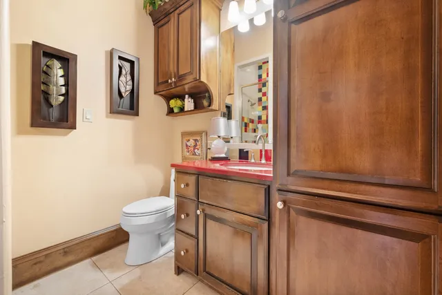 a front view of a house with a yard and potted plants
