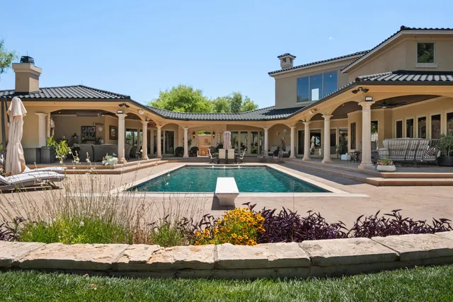 a bathroom with a toilet a sink a mirror and vanity