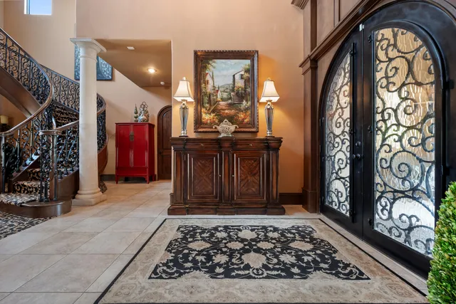 a living room with furniture and a floor to ceiling window