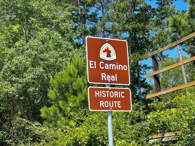 a street sign on a pole on a road