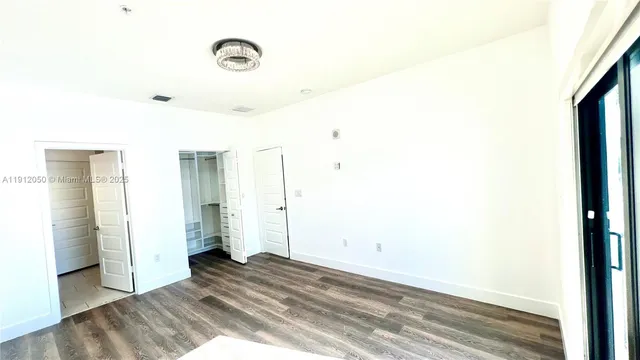 a view of a room with wooden floor