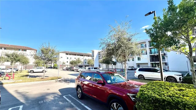 a view of a cars park in front of a building