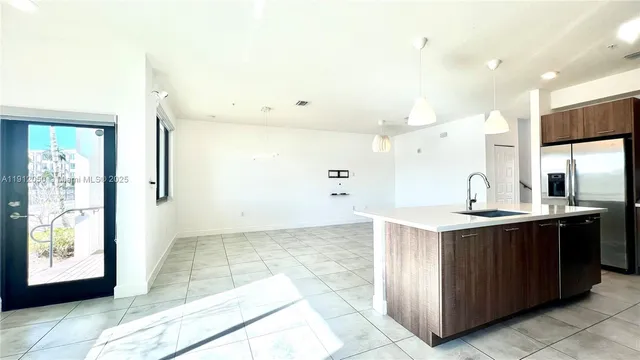 a view of a kitchen with a sink and a large window