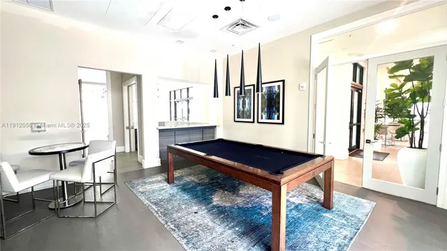 a living room with fireplace and a chandelier