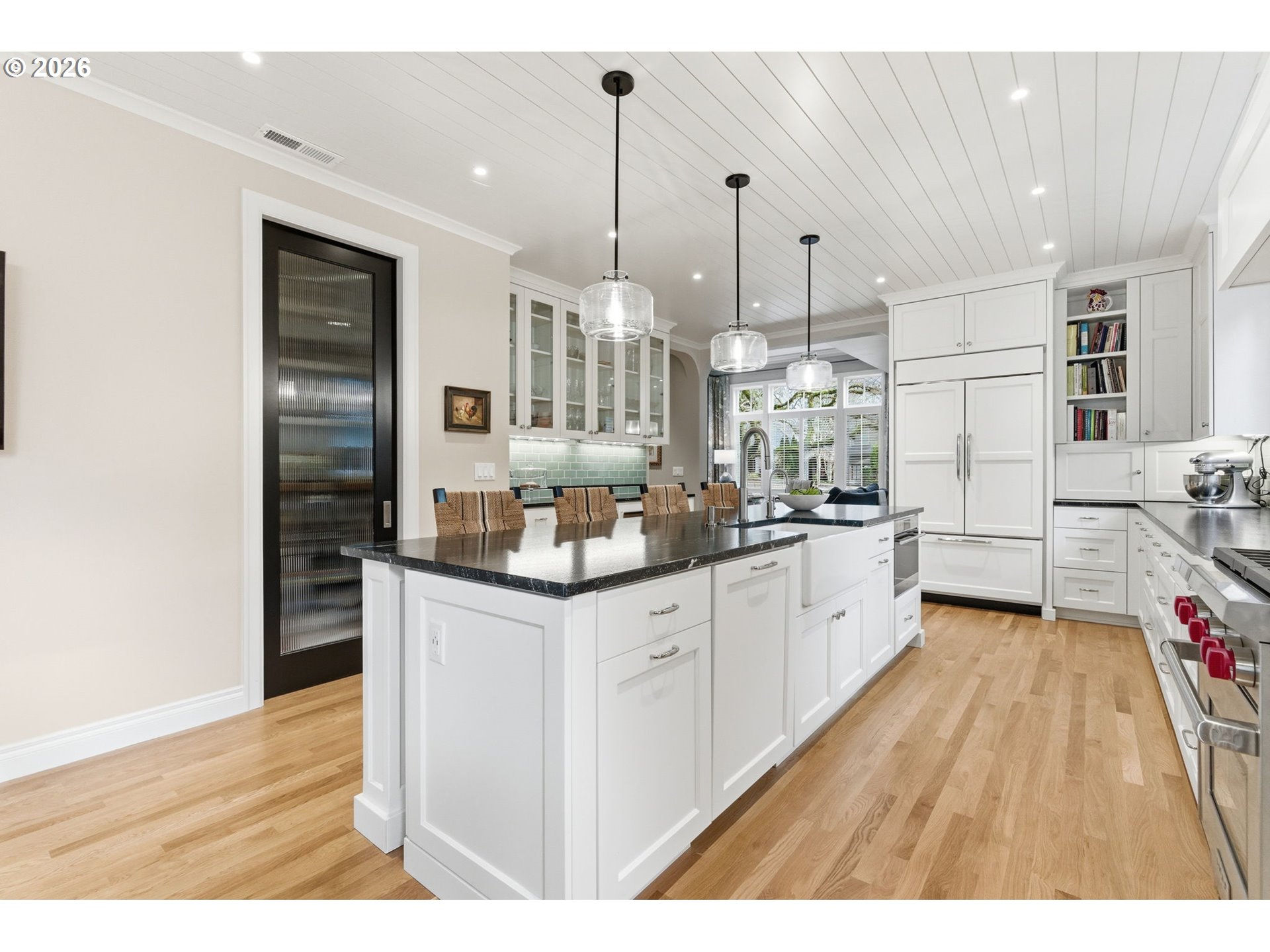 330 6th Street Lake Oswego, OR 97034 - Photo 13 of 48 a kitchen with stainless steel appliances granite countertop a sink dishwasher and white cabinets with wooden floor