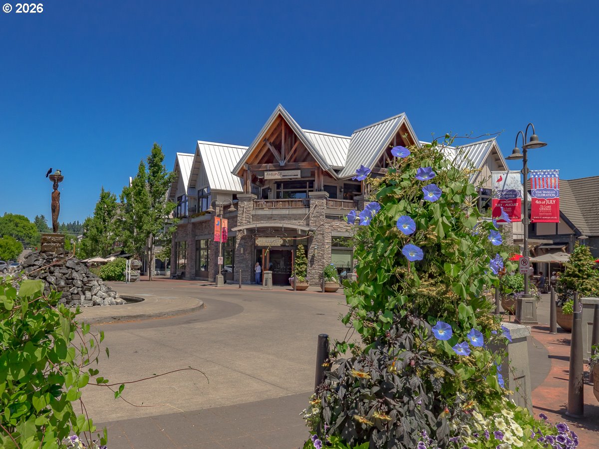330 6th Street Lake Oswego, OR 97034 - Photo 47 of 48 a front view of a house with a yard and fountain in middle