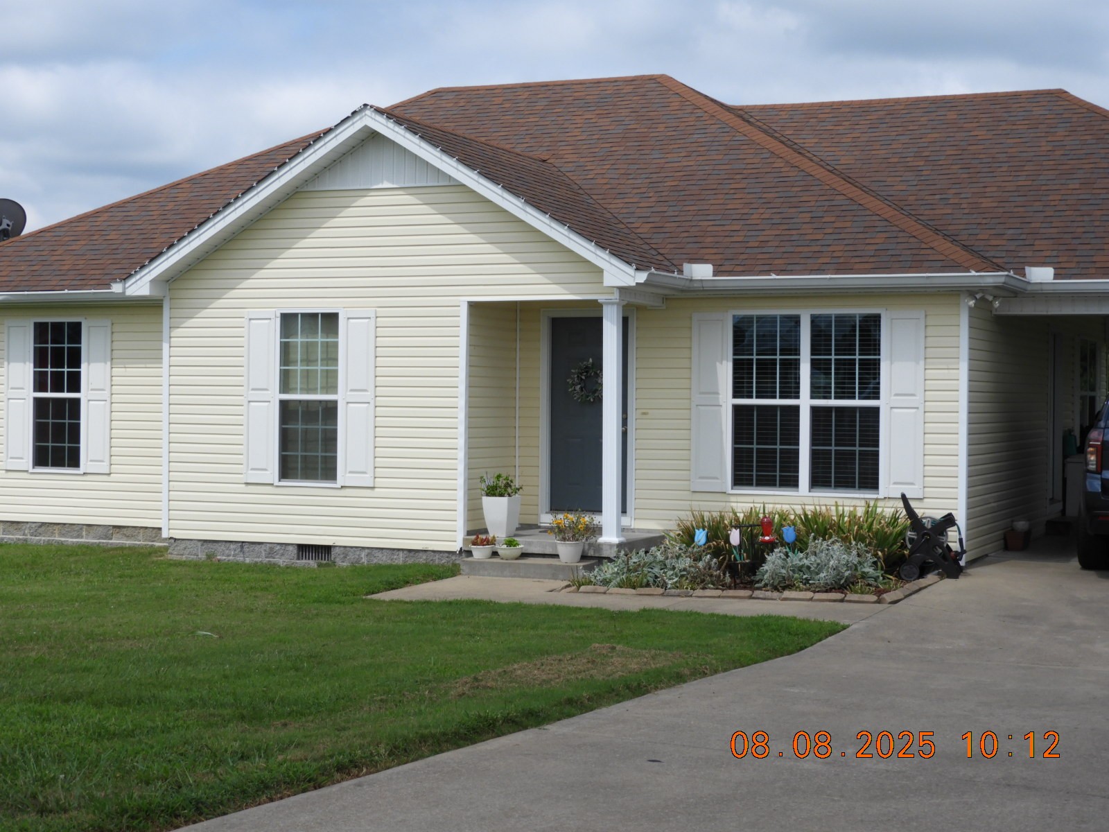 a front view of a house with a garden