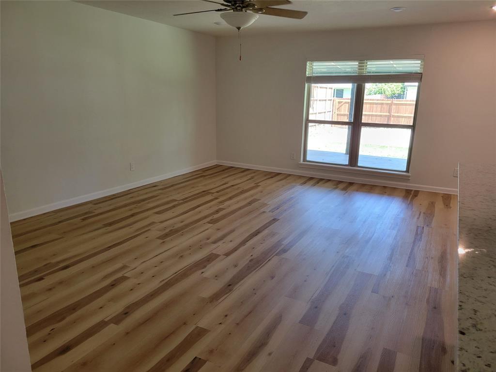 5510 Ridgecove Drive Garland, TX 75043 - Photo 3 of 11 wooden floor in an empty room with a window