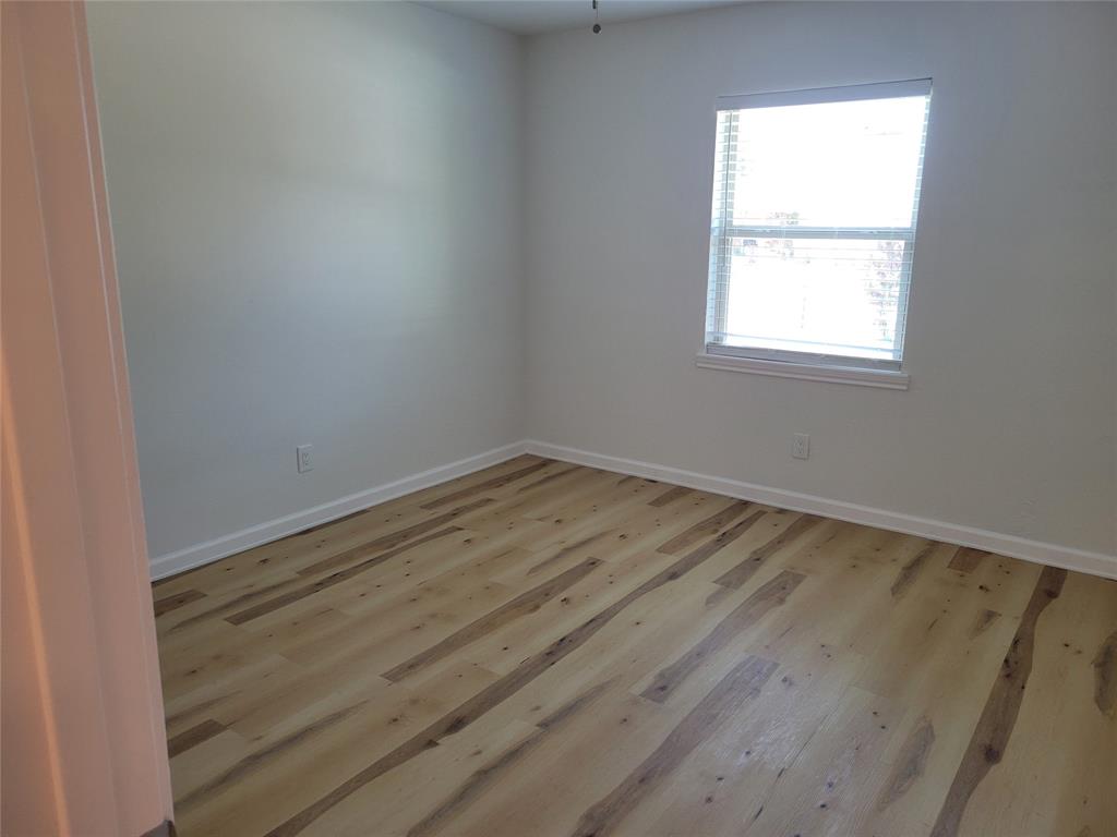 5510 Ridgecove Drive Garland, TX 75043 - Photo 6 of 11 an empty room with a window