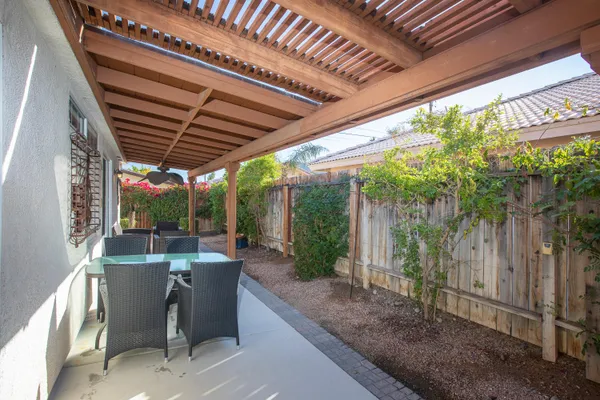 a view of a porch with chairs and couches