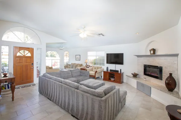 a living room with furniture fireplace and a flat screen tv