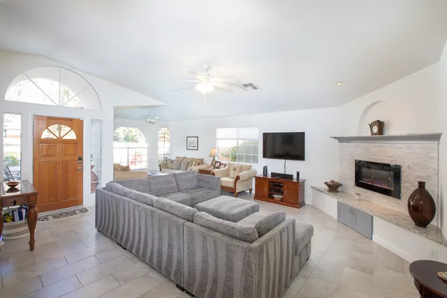 a living room with furniture fireplace and a flat screen tv