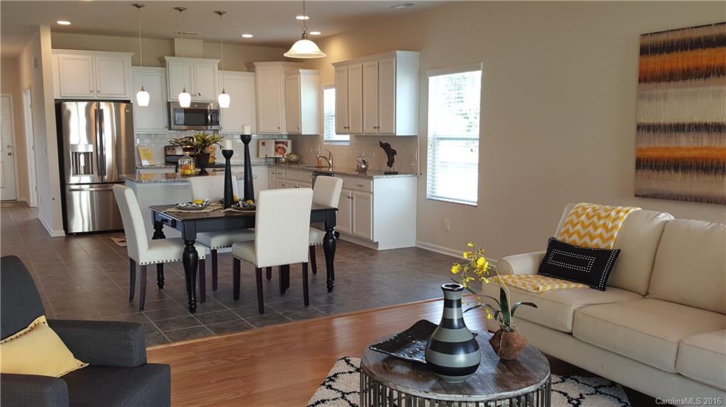 1628 Spring Blossom Trail, Unit SITE 18 Fort Mill, SC 29708 - Photo 12 of 22 a living room with furniture potted plant and kitchen view