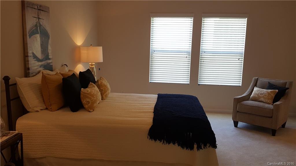 1628 Spring Blossom Trail, Unit SITE 18 Fort Mill, SC 29708 - Photo 13 of 22 a bedroom with a bed window and mirror