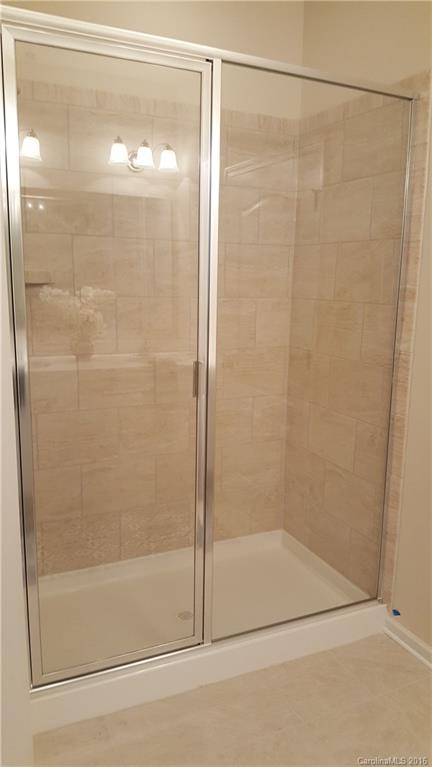1628 Spring Blossom Trail, Unit SITE 18 Fort Mill, SC 29708 - Photo 16 of 22 a bathroom with a glass shower door