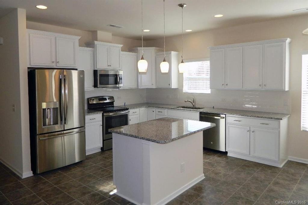 1628 Spring Blossom Trail, Unit SITE 18 Fort Mill, SC 29708 - Photo 19 of 22 a kitchen with a refrigerator sink and microwave