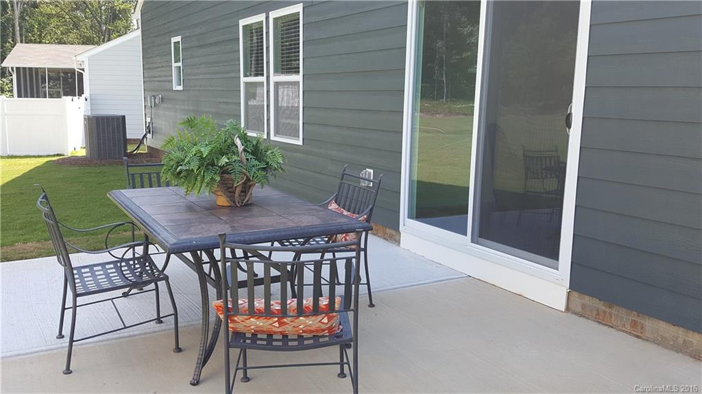 1628 Spring Blossom Trail, Unit SITE 18 Fort Mill, SC 29708 - Photo 4 of 22 a patio with a table and chairs and potted plants