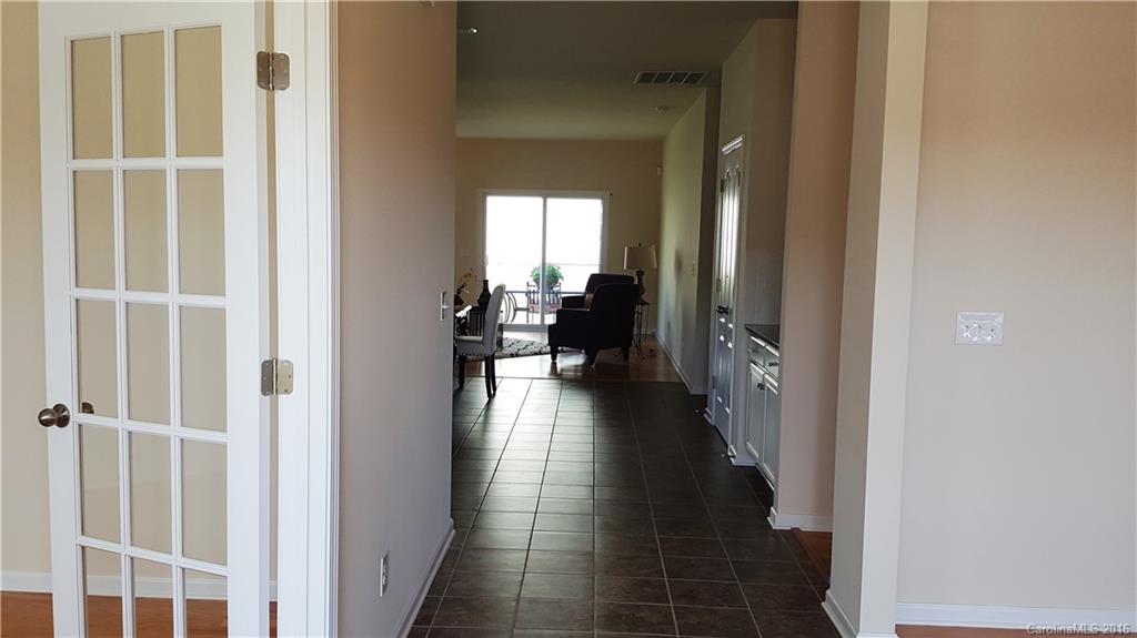 1628 Spring Blossom Trail, Unit SITE 18 Fort Mill, SC 29708 - Photo 6 of 22 a view of a hallway with wooden floor and windows